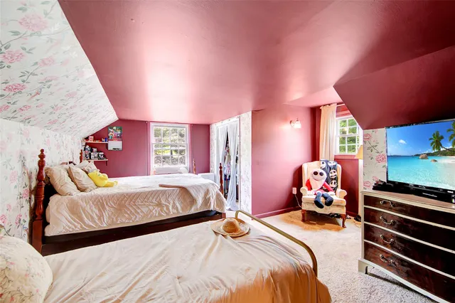 a bedroom with double bed and a window