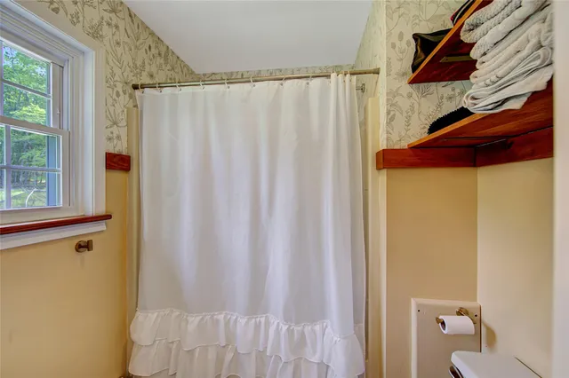 a bathroom with a shower curtain and a curtain