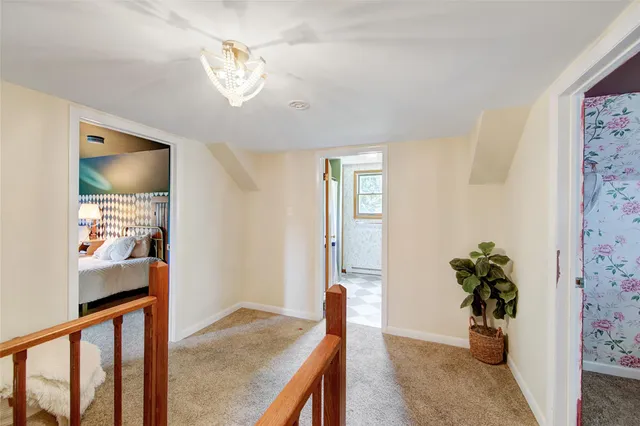 a view of a hallway to a livingroom with furniture