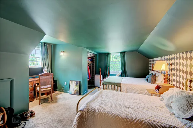 a bedroom with a bed and a mirror