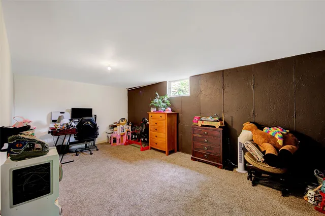 a bedroom with furniture and a fan