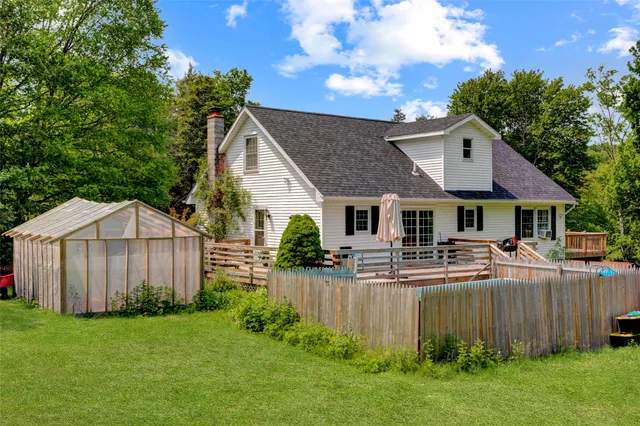 a front view of house with yard and trees