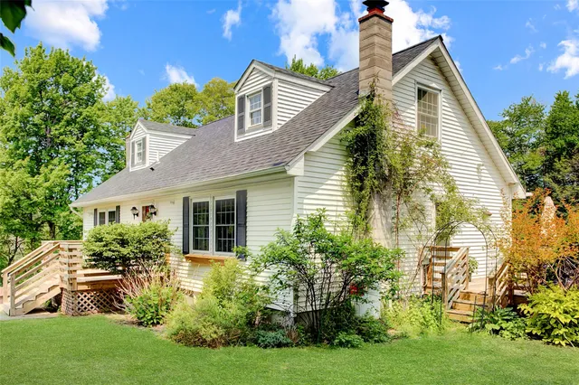 a front view of house with yard and green space