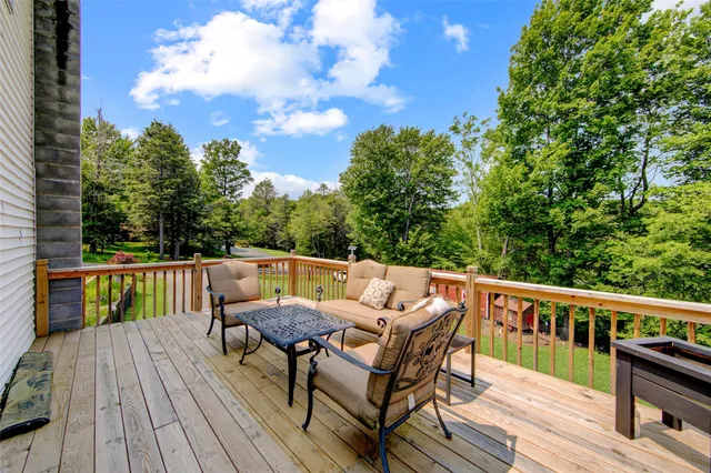 a view of a patio on wooden deck and mountain view