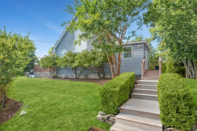 a kitchen with kitchen island a stove a sink a center island and wooden floor