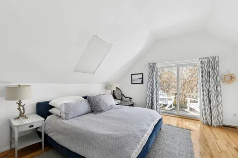 a bedroom with a large bed and a large window