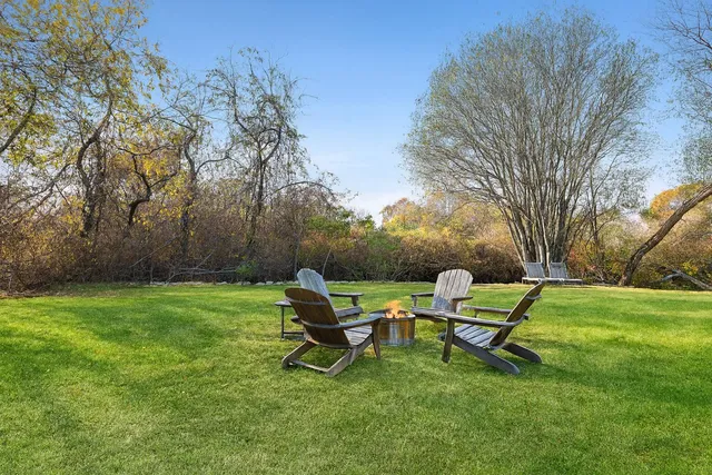 a view of a backyard with wooden fence