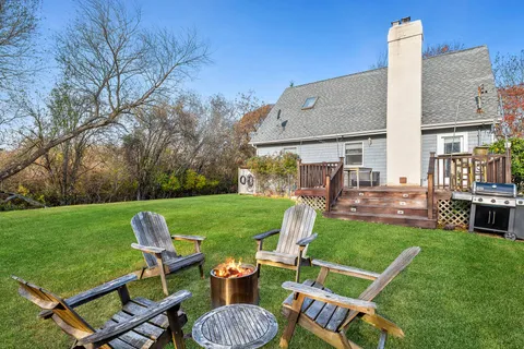 a view of an chairs and table in backyard of the house