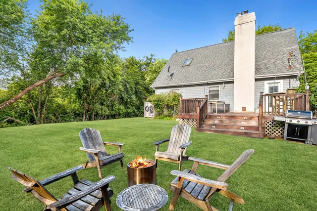 a kitchen with stainless steel appliances a sink dishwasher a stove and white cabinets with wooden floor