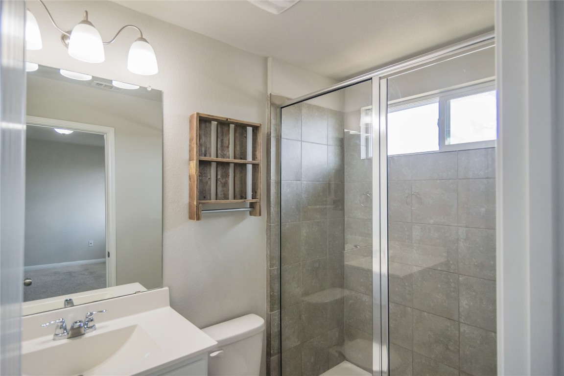 332 Cane River Road Pflugerville, TX 78660 - Photo 18 of 30 a bathroom with a shower and a sink