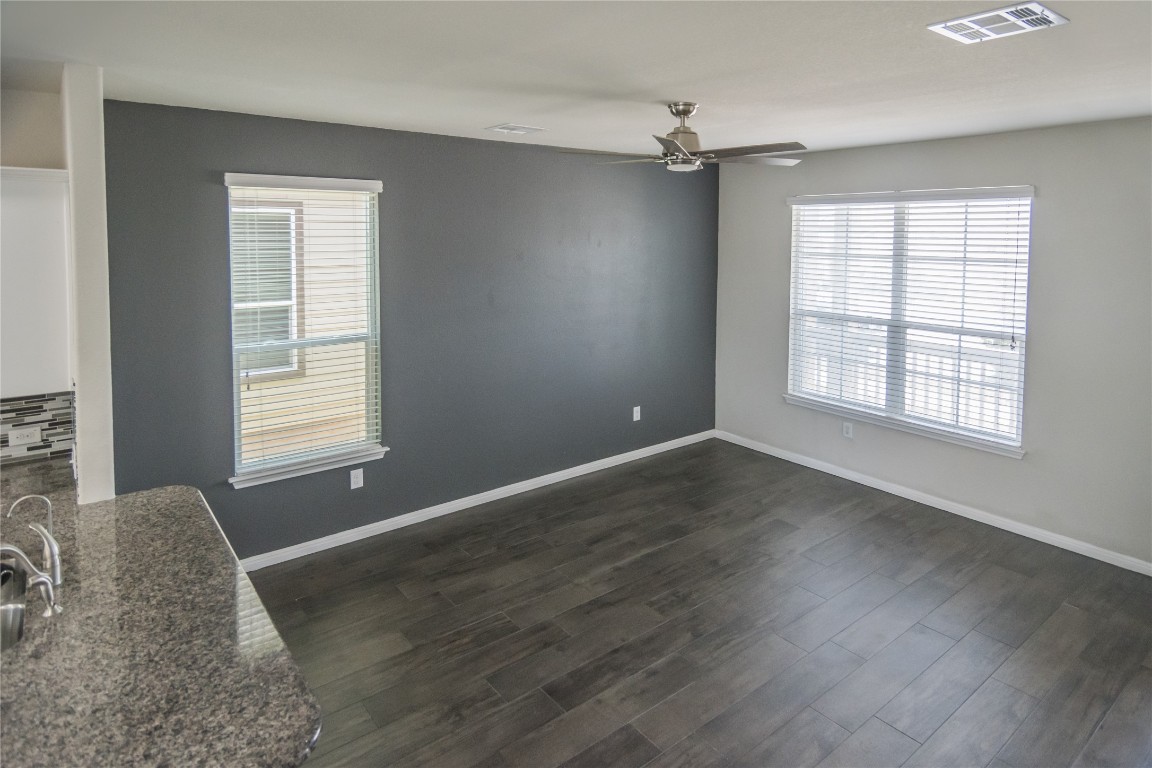 332 Cane River Road Pflugerville, TX 78660 - Photo 24 of 30 an empty room with wooden floor and windows