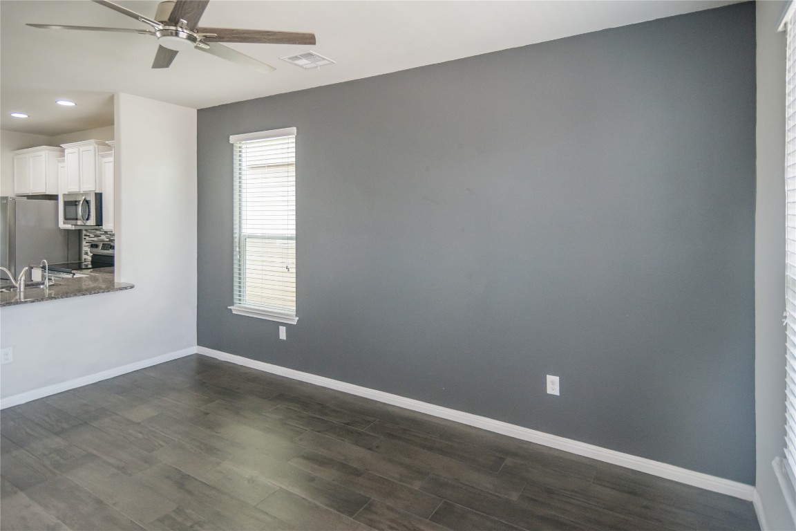 332 Cane River Road Pflugerville, TX 78660 - Photo 5 of 30 wooden floor in an empty room with a window
