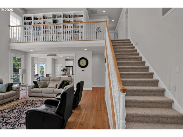 a view of livingroom with furniture staircase and windows