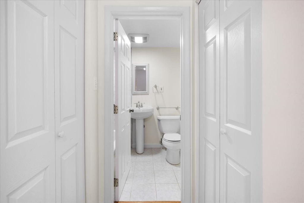 4925 Washington Street, Unit 304 Boston, MA 02132 - Photo 13 of 25 a bathroom with a toilet and a sink