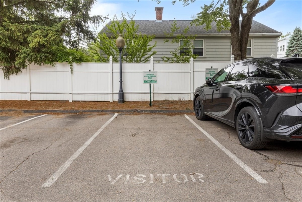 4925 Washington Street, Unit 304 Boston, MA 02132 - Photo 24 of 25 a front view of a house with a garden