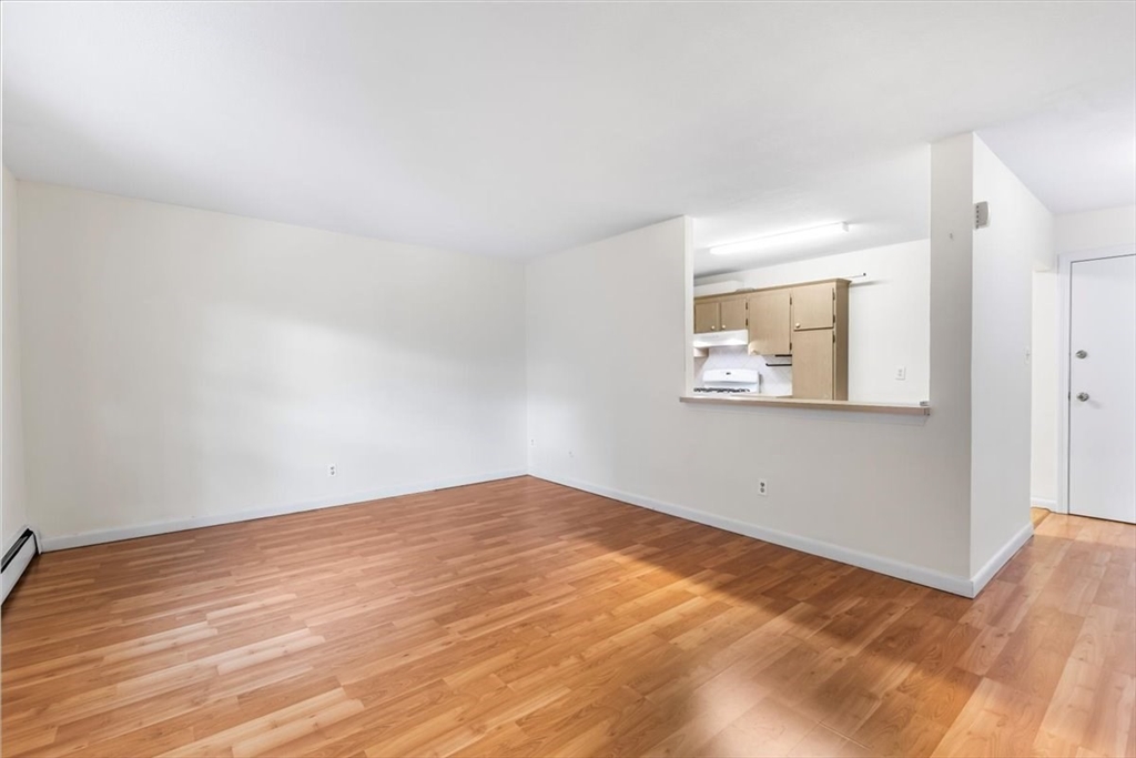 4925 Washington Street, Unit 304 Boston, MA 02132 - Photo 4 of 25 a view of empty room with wooden floor
