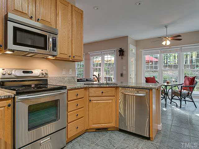 805 Bromley Way Raleigh, NC 27615 - Photo 24 of 25 Kitchen has tile floors, Granite and Stainless Appliances. Open floor plan to breakfast area and living room. Kitchen