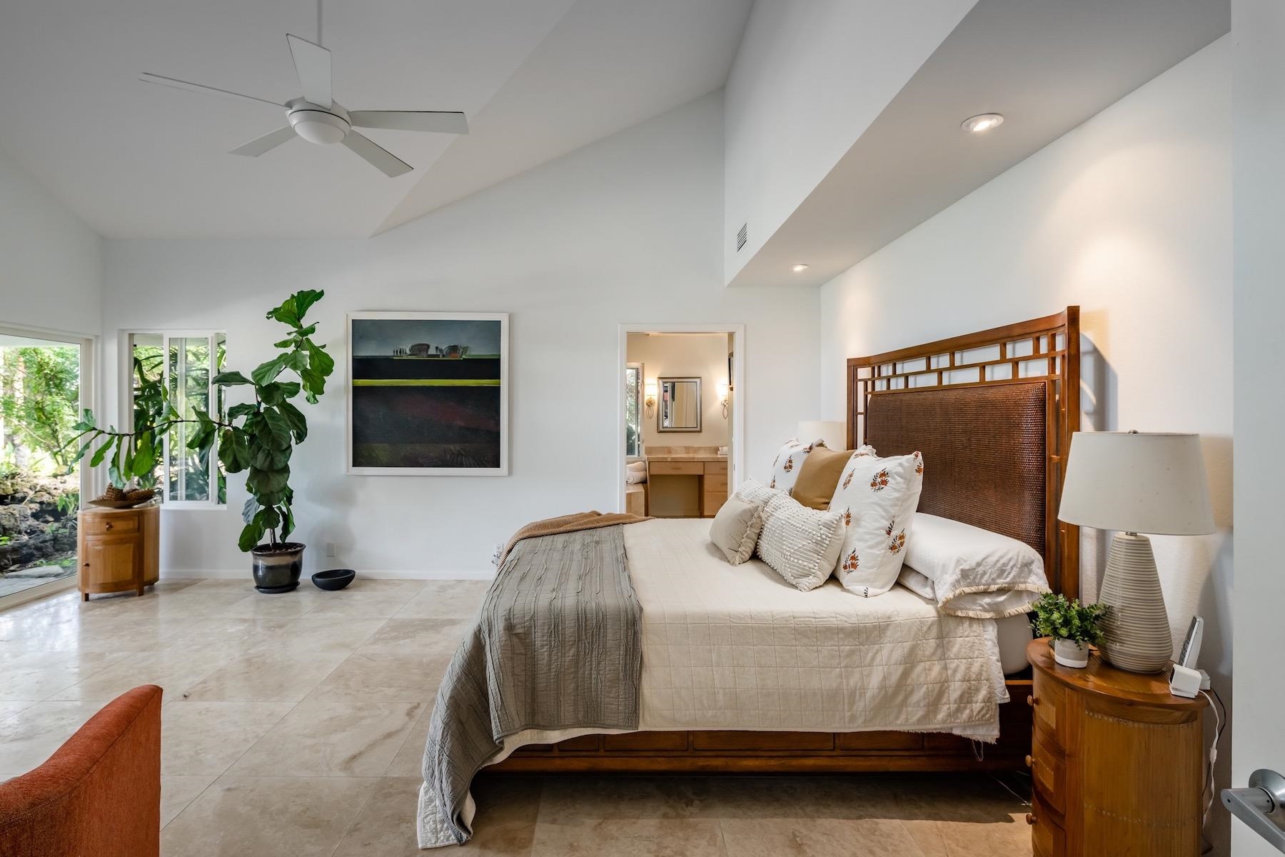110 Mehana Road Haiku, HI 96708 - Photo 18 of 30 a bedroom with a bed a couch and potted plant
