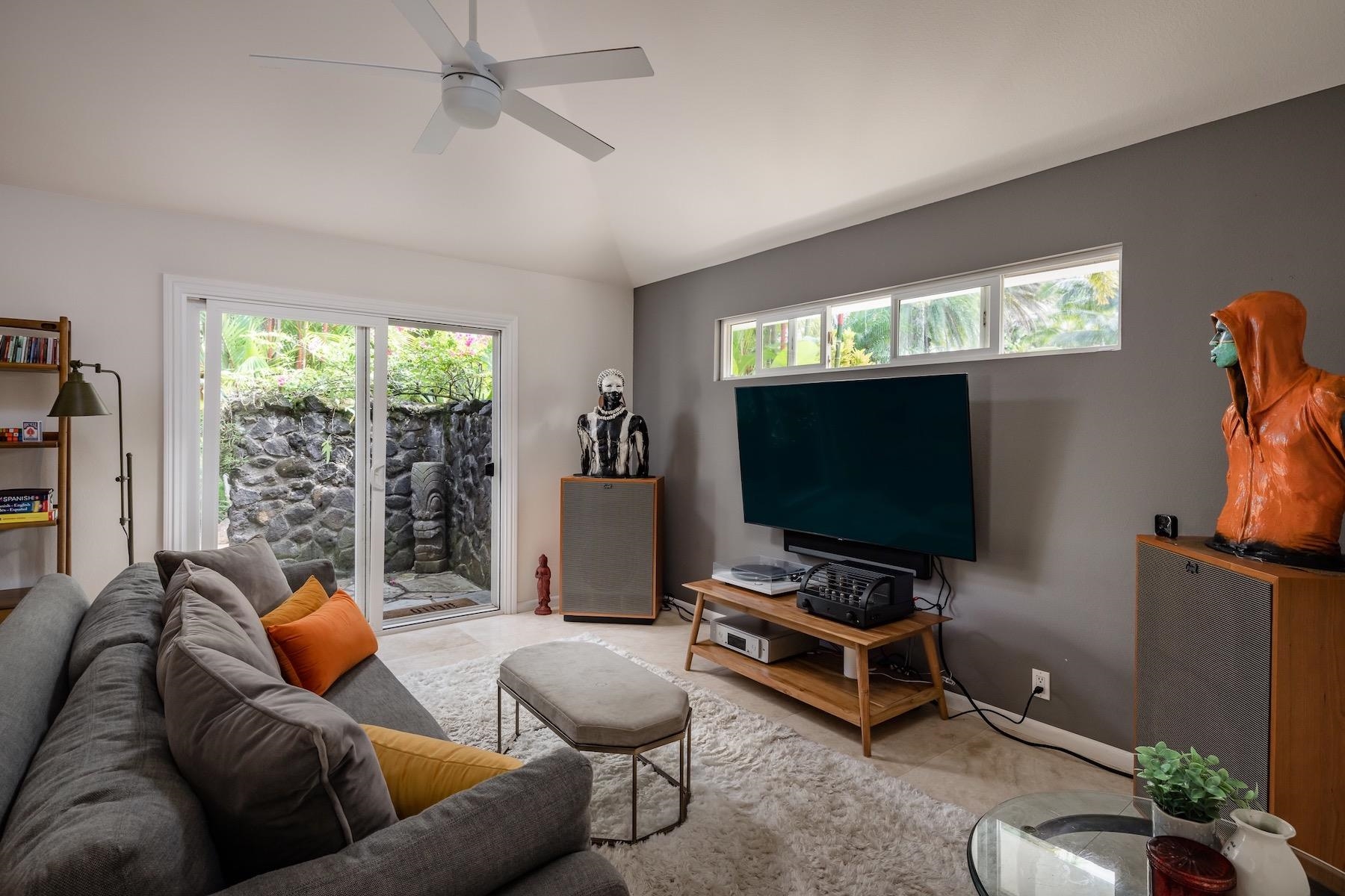 110 Mehana Road Haiku, HI 96708 - Photo 25 of 30 a living room with furniture and a flat screen tv