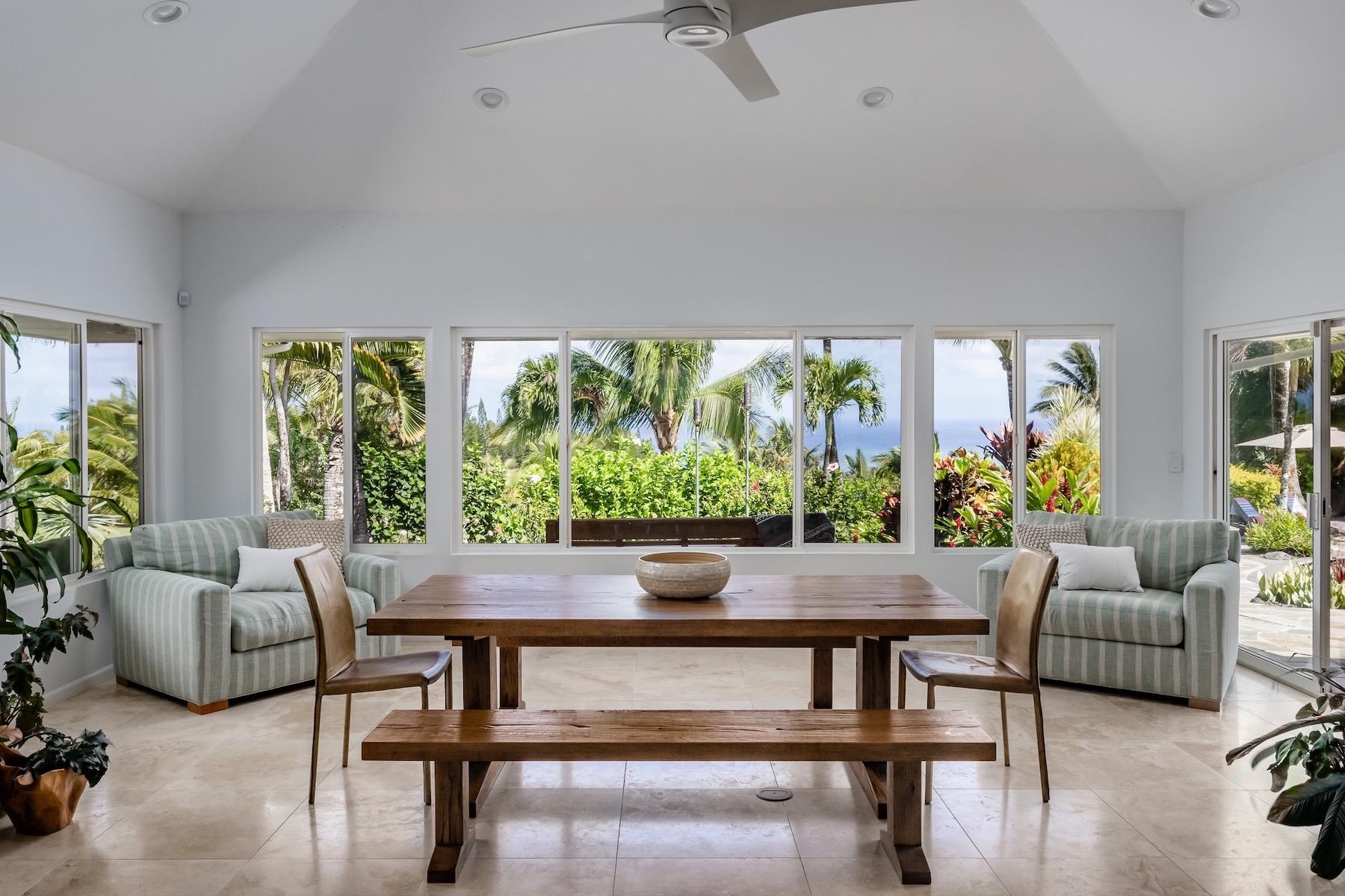 110 Mehana Road Haiku, HI 96708 - Photo 8 of 30 a living room with furniture and a floor to ceiling window