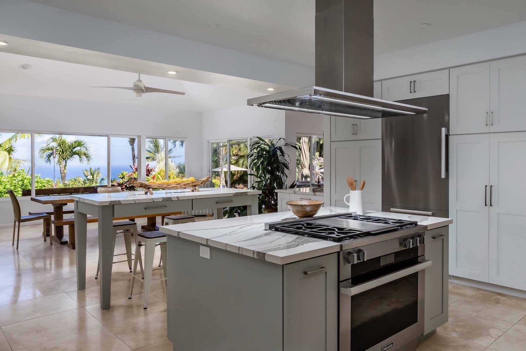 110 Mehana Road Haiku, HI 96708 - Photo 9 of 30 a kitchen with a stove and a table