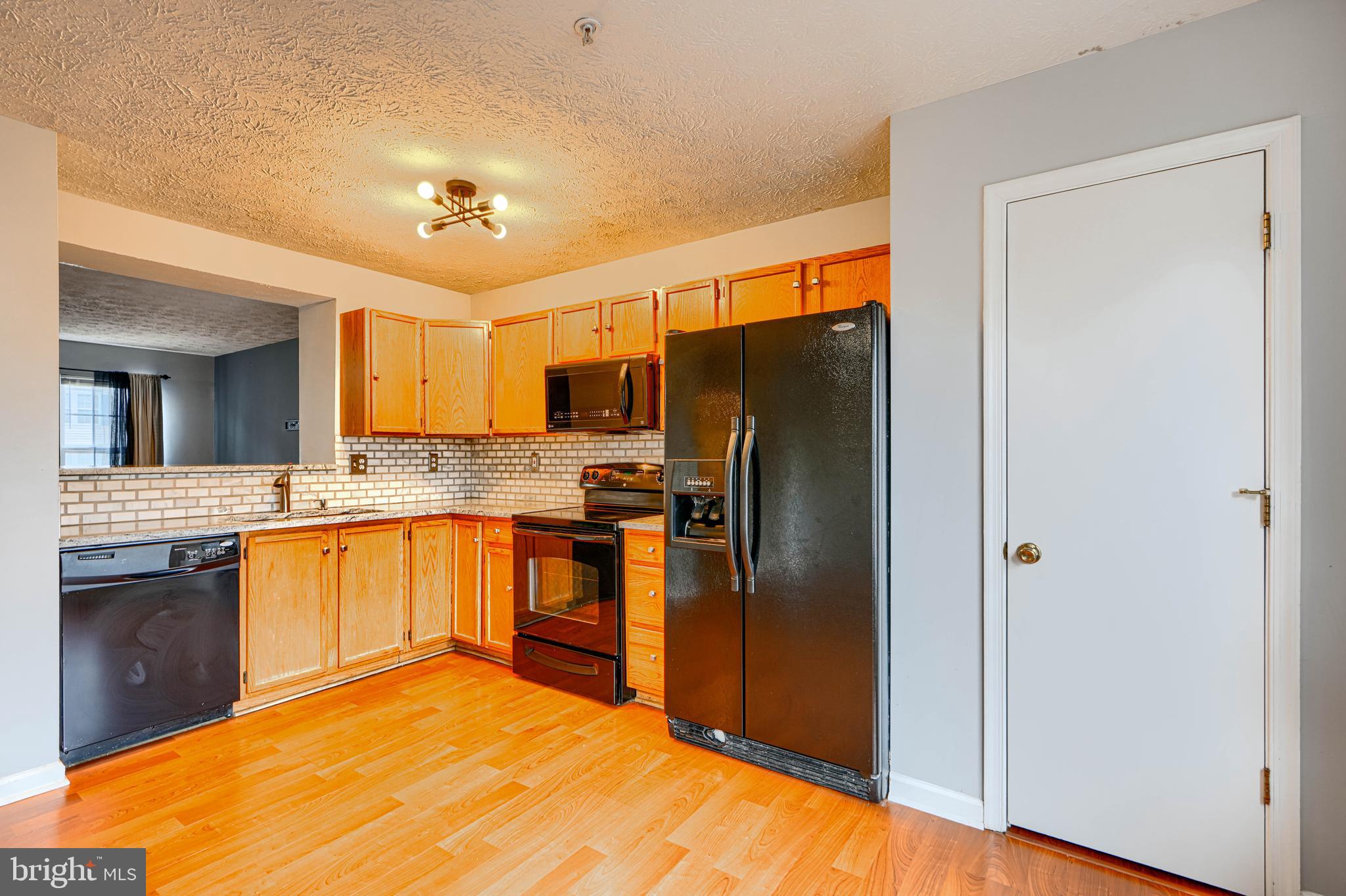 62 Gwynnswood Road Owings Mills, MD 21117 - Photo 12 of 44 a kitchen with stainless steel appliances granite countertop a refrigerator a stove top oven a sink and dishwasher