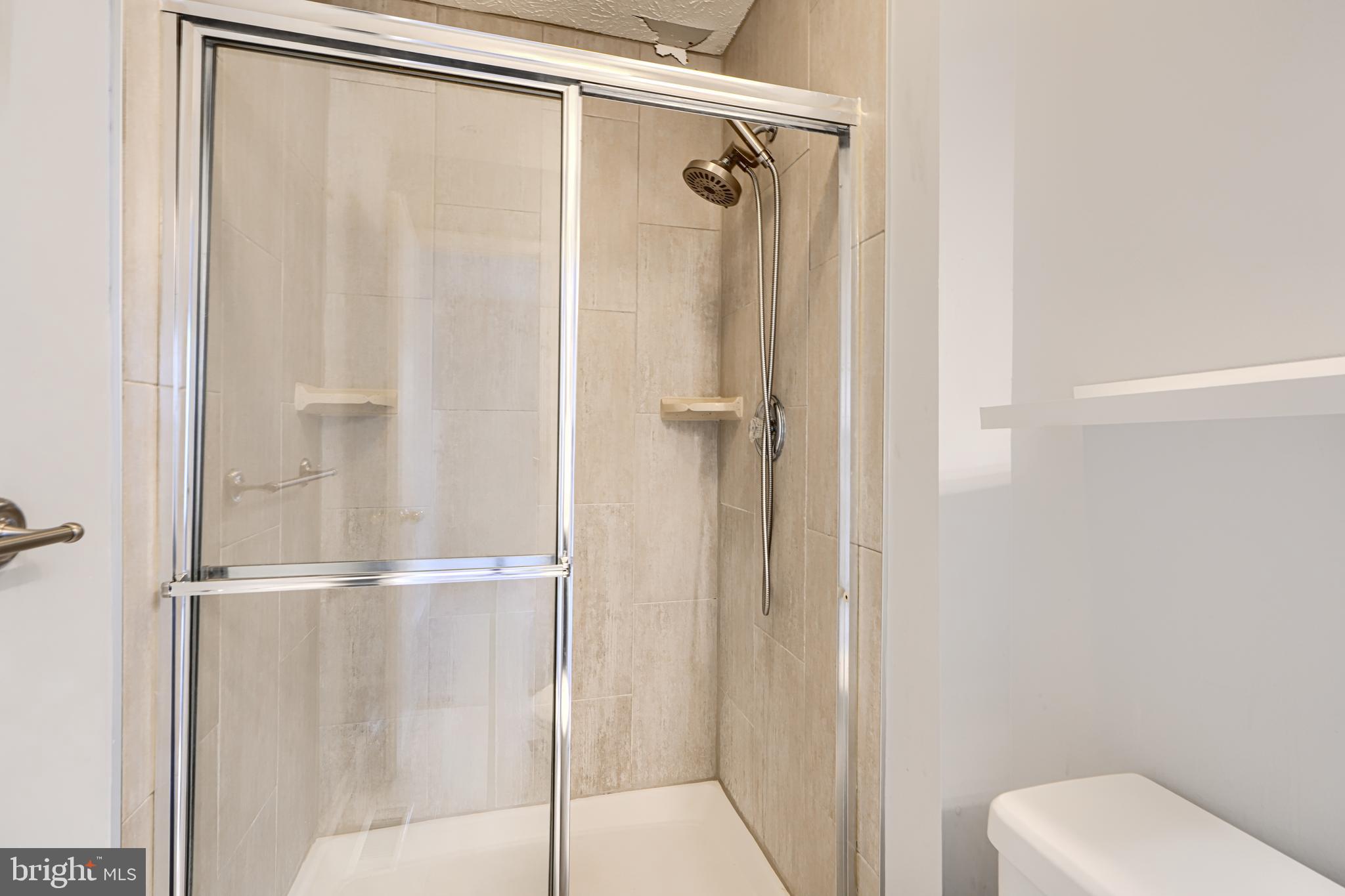 62 Gwynnswood Road Owings Mills, MD 21117 - Photo 21 of 44 a bathroom with a glass shower door