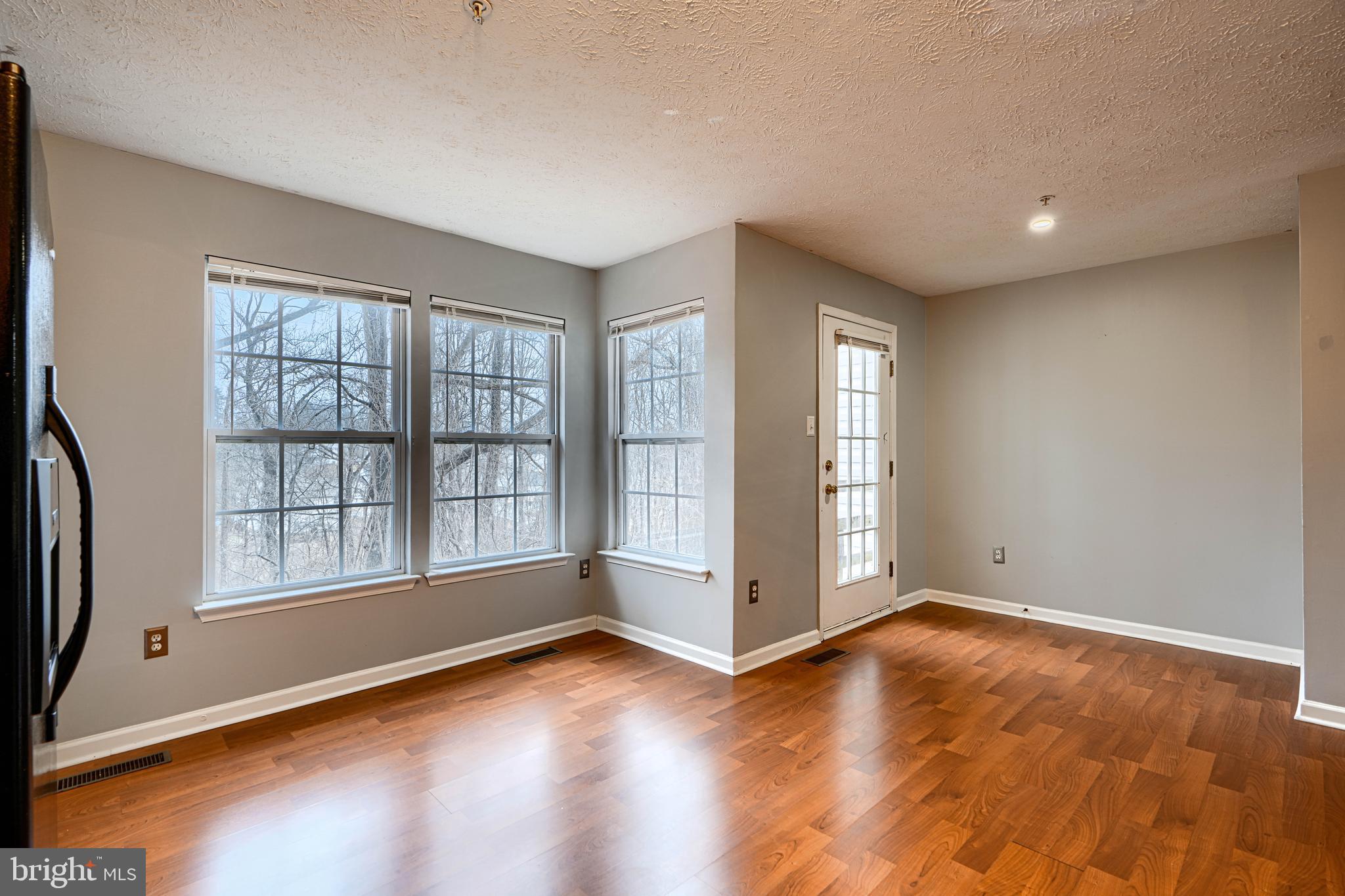 62 Gwynnswood Road Owings Mills, MD 21117 - Photo 10 of 44 an empty room with wooden floor and windows