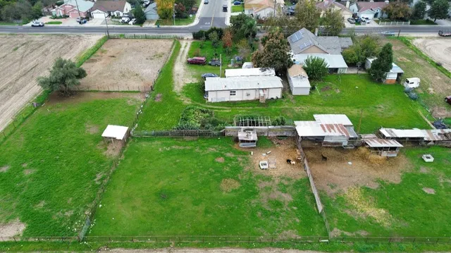 an aerial view of a house with pool garden and outdoor seating