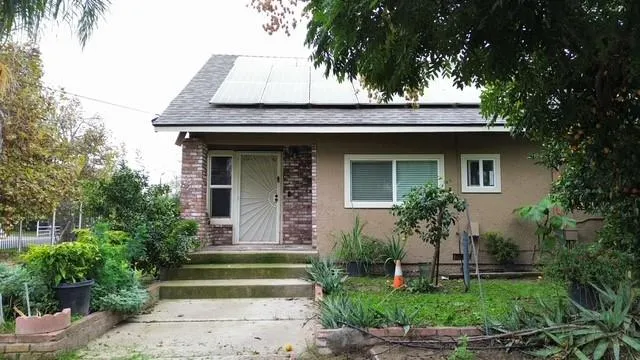 a front view of a house with a garden