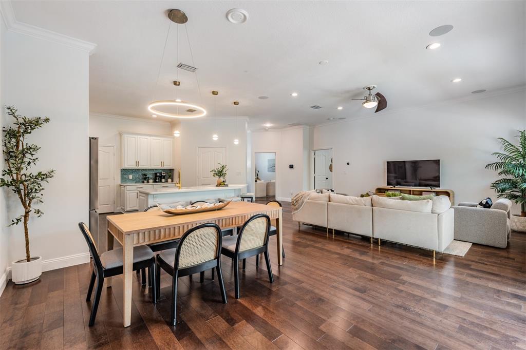 4003 South Shamrock Road Tampa, FL 33611 - Photo 11 of 38 a view of a dining room with furniture and wooden floor