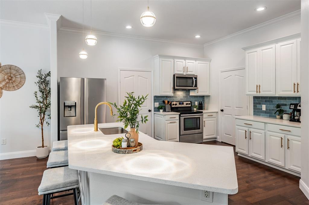 4003 South Shamrock Road Tampa, FL 33611 - Photo 14 of 38 a kitchen with sink a microwave and refrigerator