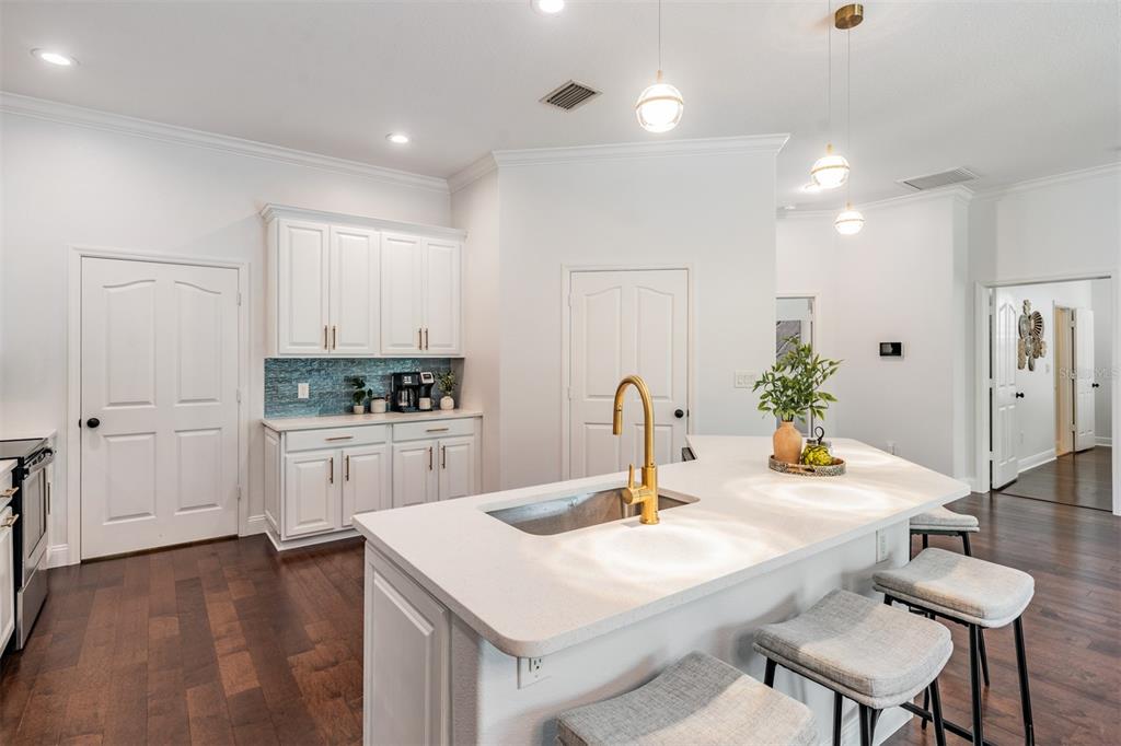 4003 South Shamrock Road Tampa, FL 33611 - Photo 17 of 38 a kitchen with a sink cabinets and wooden floor