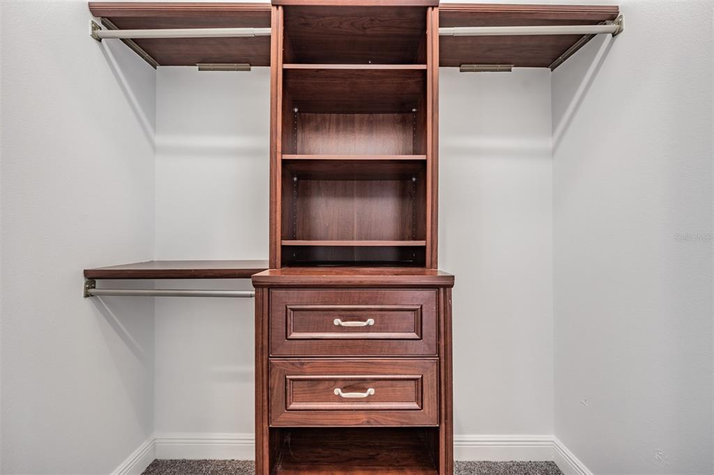 4003 South Shamrock Road Tampa, FL 33611 - Photo 21 of 38 a view of walk in closet with empty racks