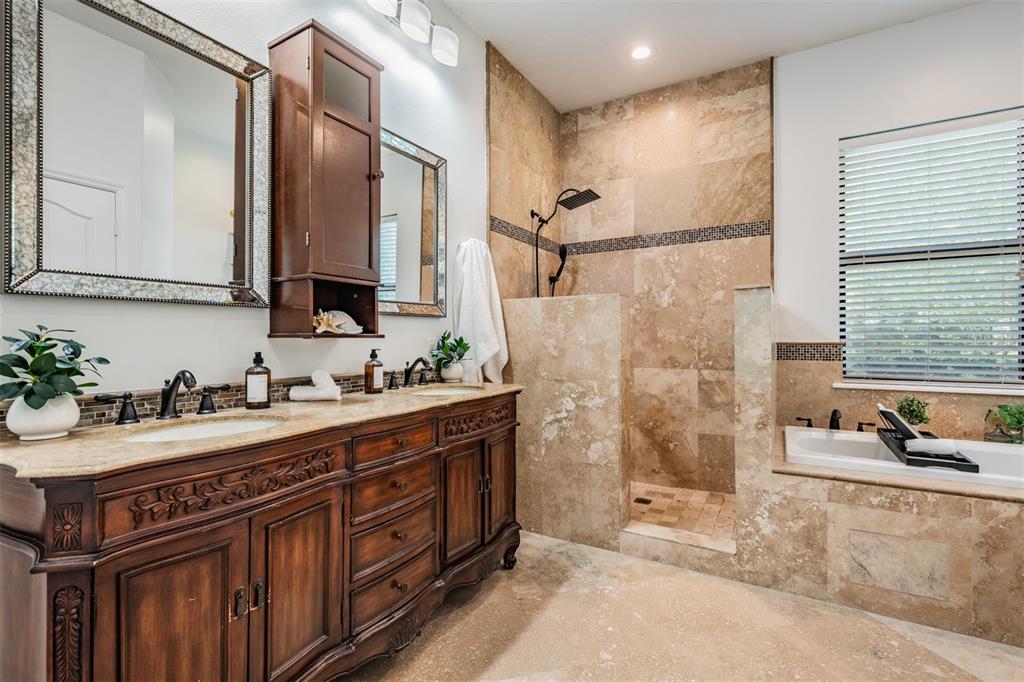 4003 South Shamrock Road Tampa, FL 33611 - Photo 22 of 38 a bathroom with a sink and a mirror