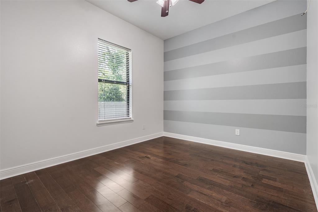 4003 South Shamrock Road Tampa, FL 33611 - Photo 26 of 38 wooden floor in an empty room with a window