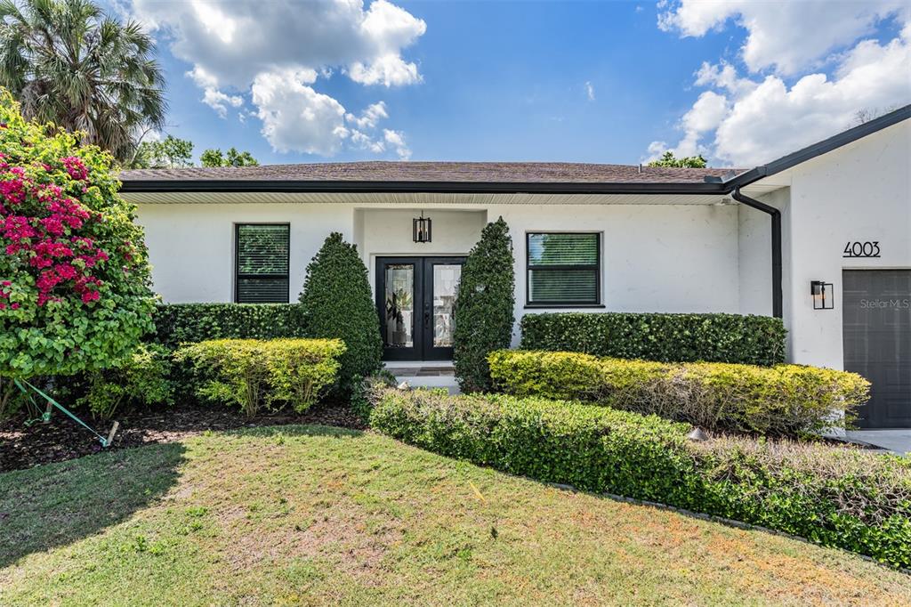 4003 South Shamrock Road Tampa, FL 33611 - Photo 4 of 38 a front view of a house with a yard