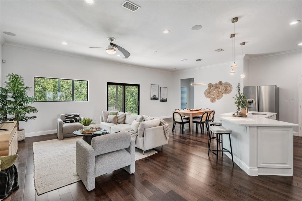 4003 South Shamrock Road Tampa, FL 33611 - Photo 7 of 38 a living room with furniture a large window and wooden floor