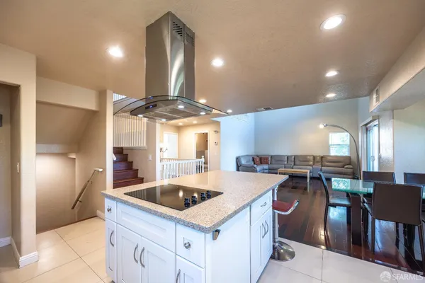 a kitchen with a sink a counter top space and stainless steel appliances