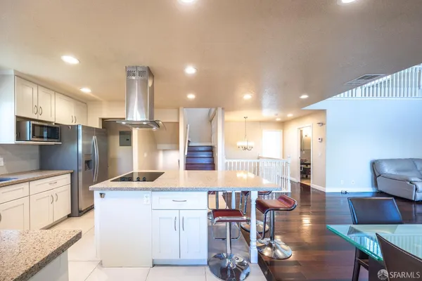 a large kitchen with a table and chairs