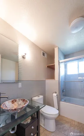 a bathroom with a sink a toilet and bathtub
