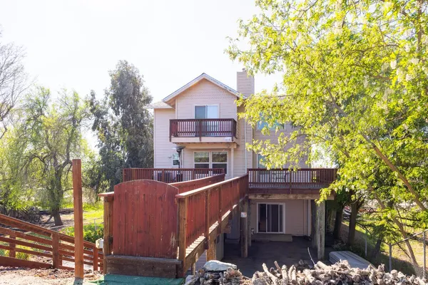 a house view with a tree in front of it