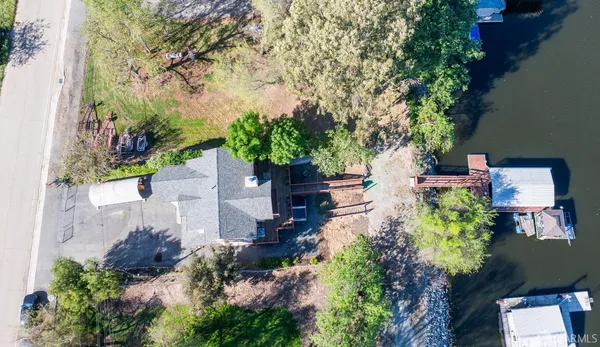 an aerial view of a house with a yard