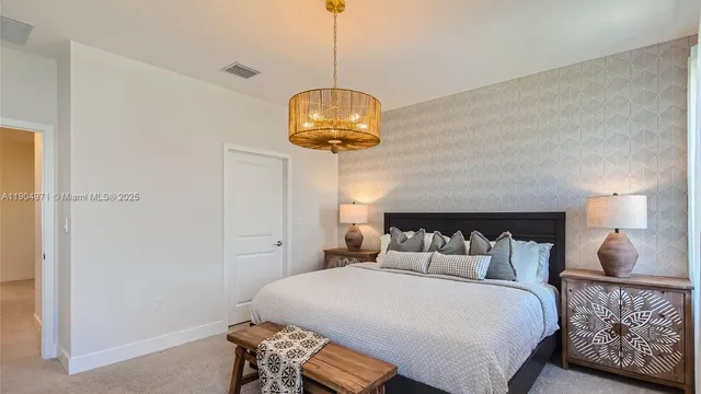 a bedroom with a bed and a chandelier