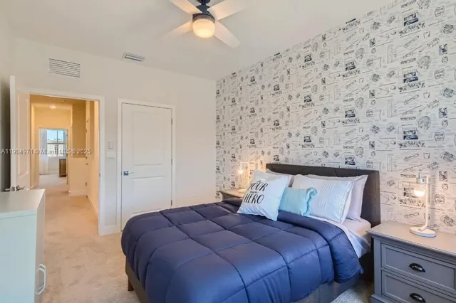 a bedroom with a bed and a chandelier fan