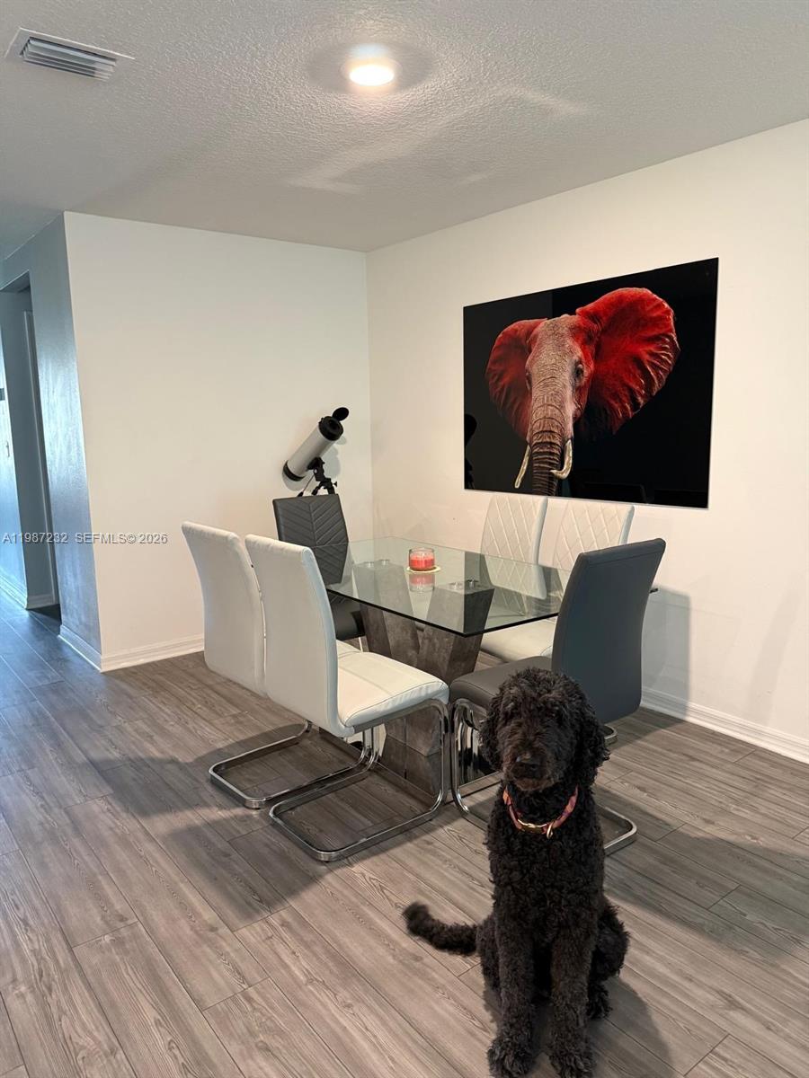 3902 Southwest Brunswick Street Port St. Lucie, FL 34953 - Photo 11 of 23 a living room with furniture wooden floor and a flat screen tv