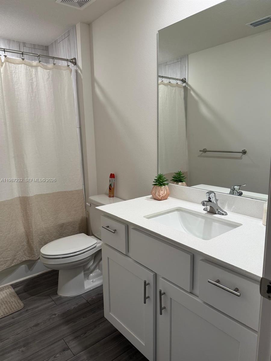 3902 Southwest Brunswick Street Port St. Lucie, FL 34953 - Photo 14 of 23 a bathroom with a sink toilet and shower