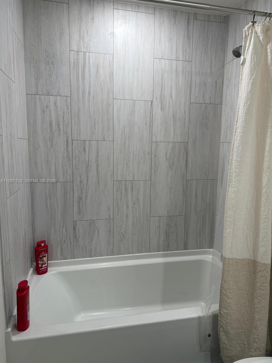3902 Southwest Brunswick Street Port St. Lucie, FL 34953 - Photo 15 of 23 a bathroom with a bathtub and shower