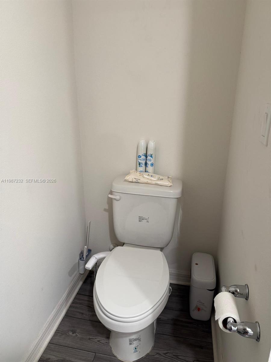 3902 Southwest Brunswick Street Port St. Lucie, FL 34953 - Photo 16 of 23 a white toilet sitting next to a bathroom sink