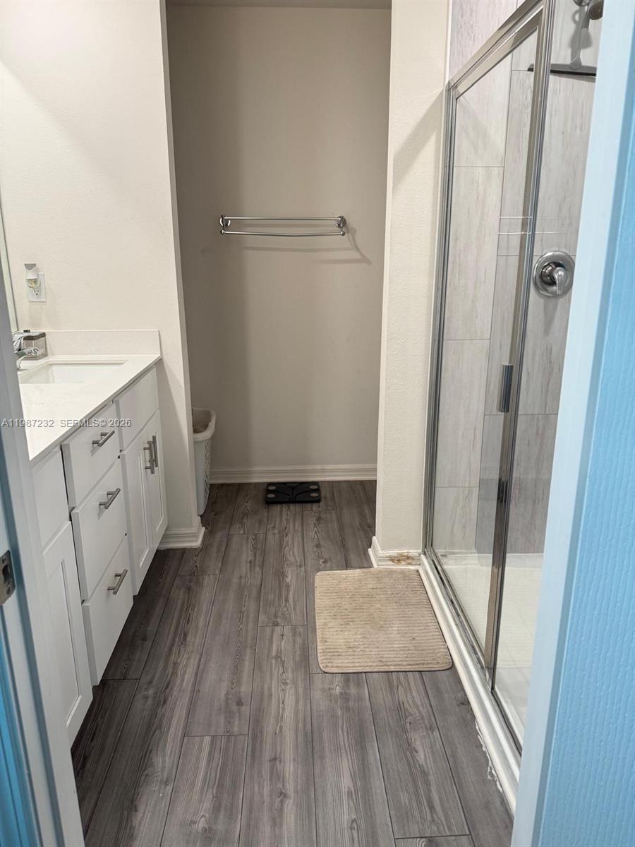 3902 Southwest Brunswick Street Port St. Lucie, FL 34953 - Photo 17 of 23 a view of walk in closet with wooden floor and cabinet